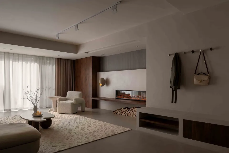 Modern minimalist living room featuring a concrete fireplace and white furniture