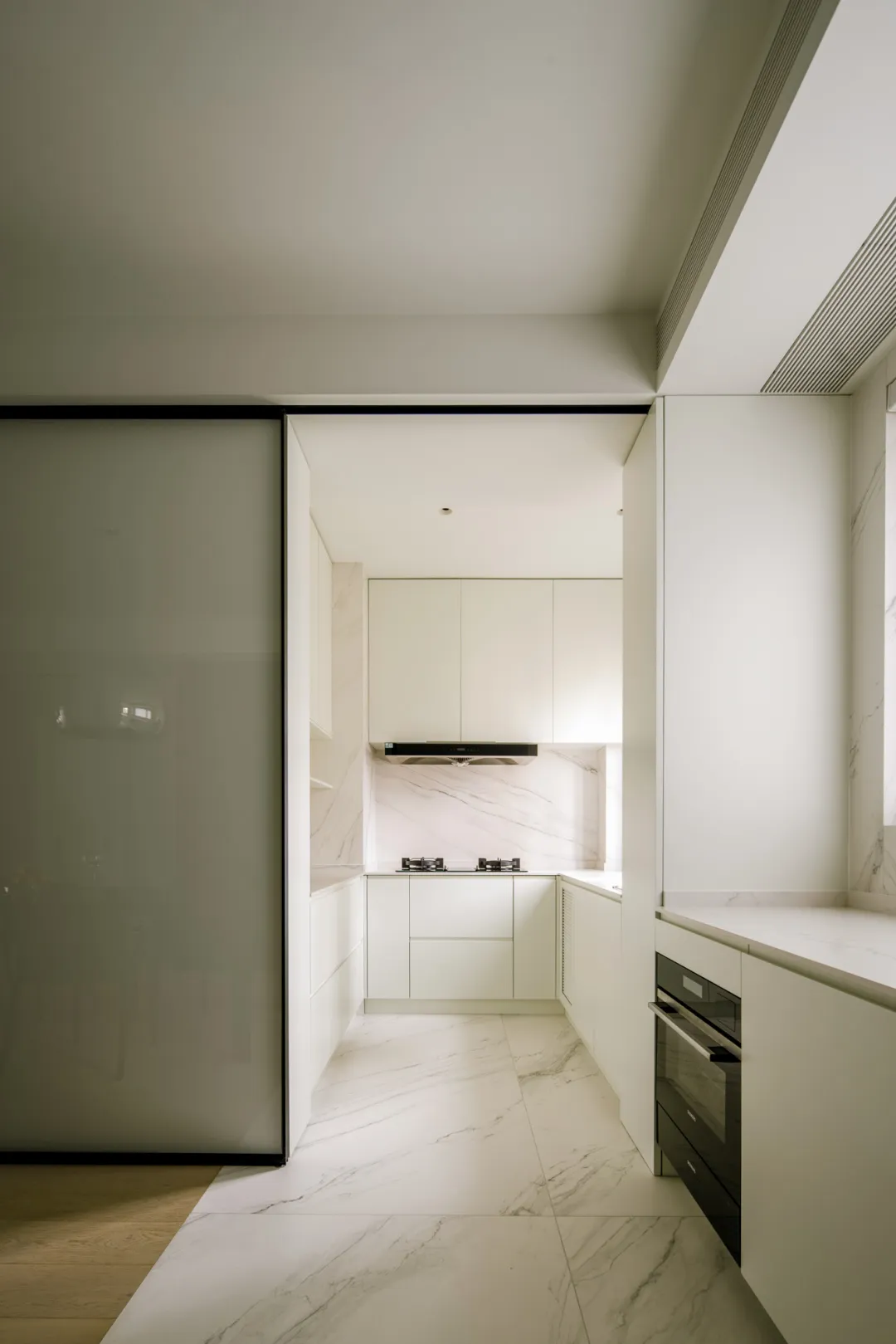 Modestly designed white marble kitchen with minimalist aesthetics