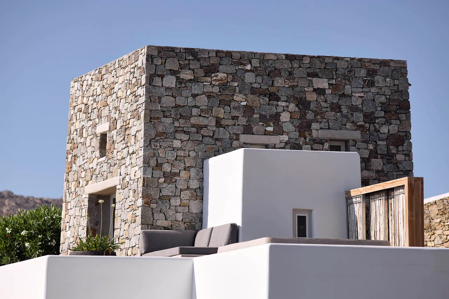 A minimalist building with stone exteriors featuring clean lines and a simple aesthetic.