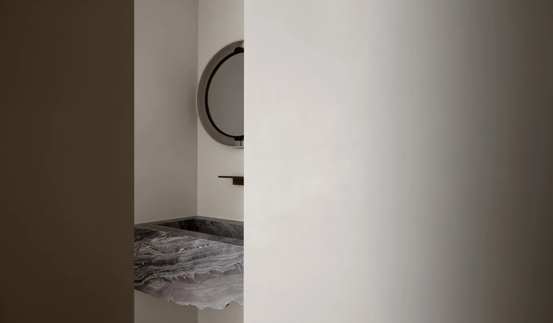 Modern bathroom featuring a marble sink with minimalist design elements.