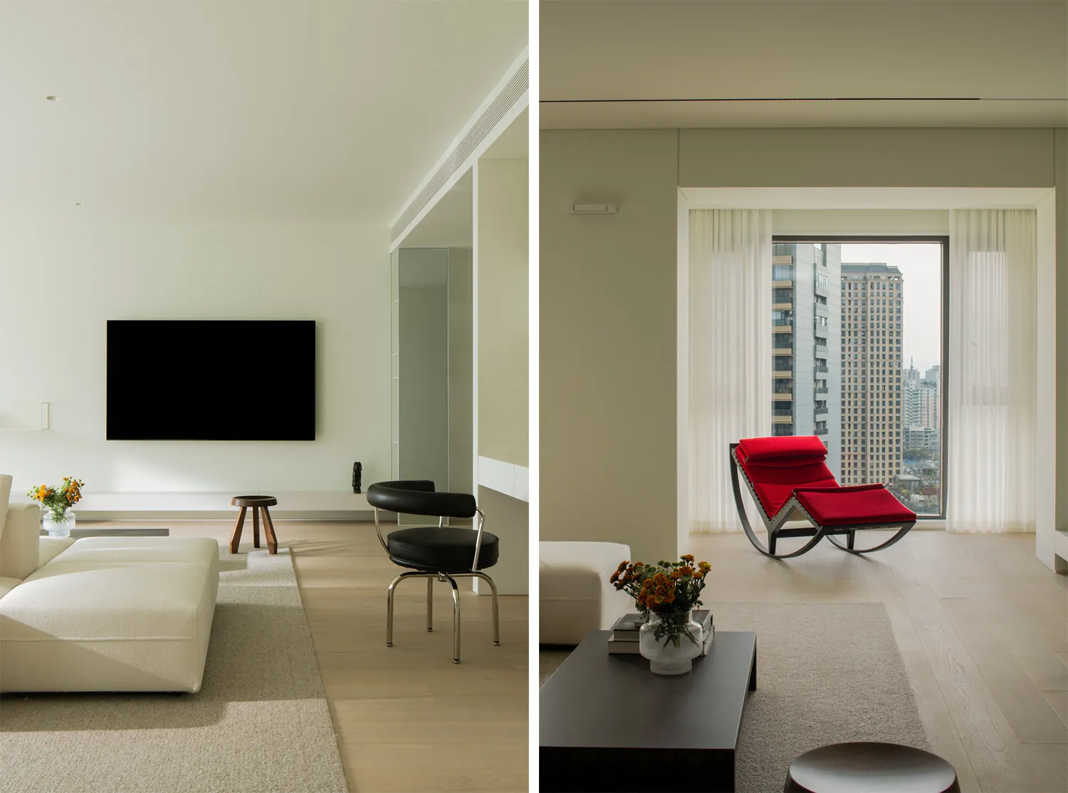 Modern minimalist living room with white furniture, red accent chair, and city view.