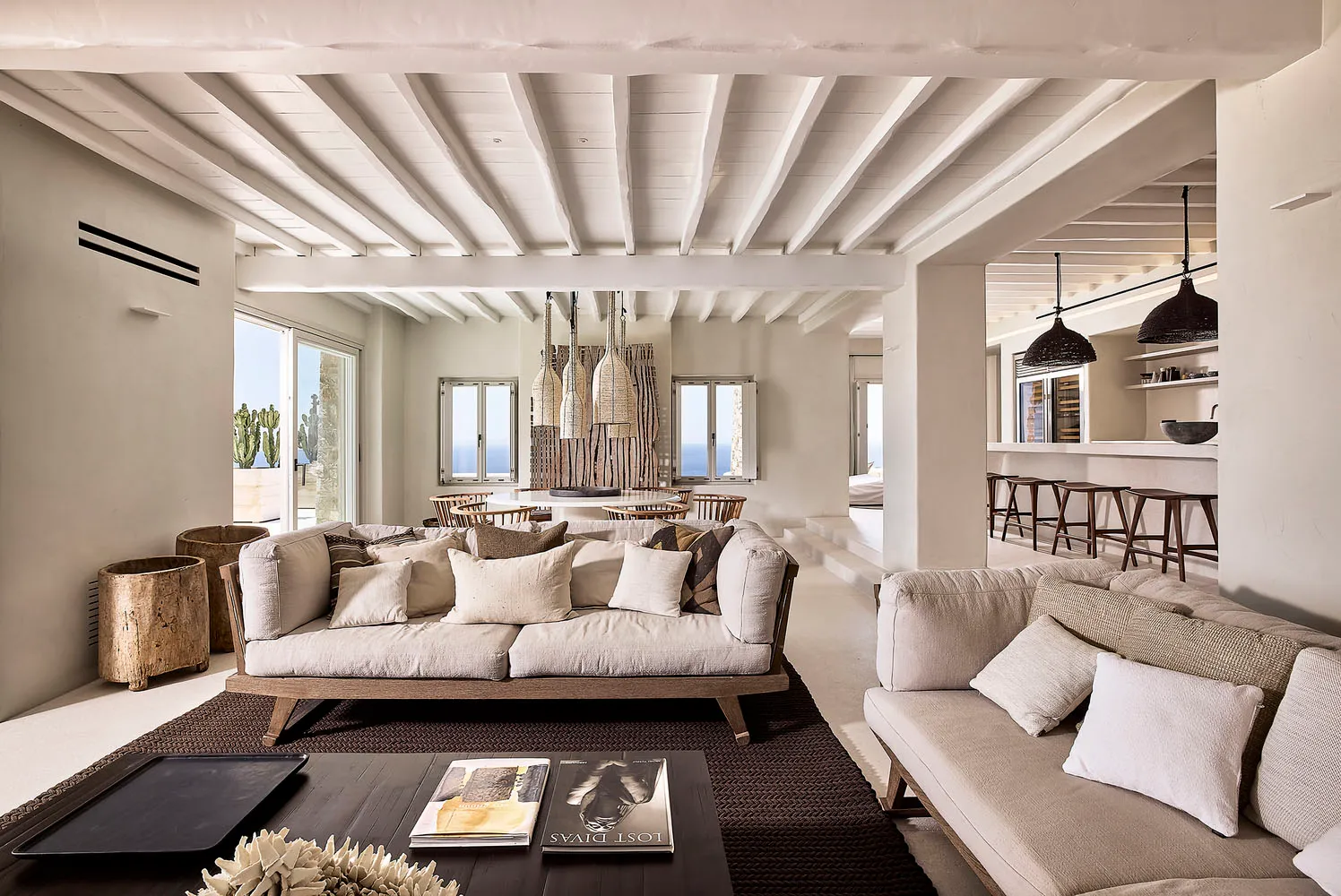 A spacious, modern living room with neutral-toned furniture and decor.
