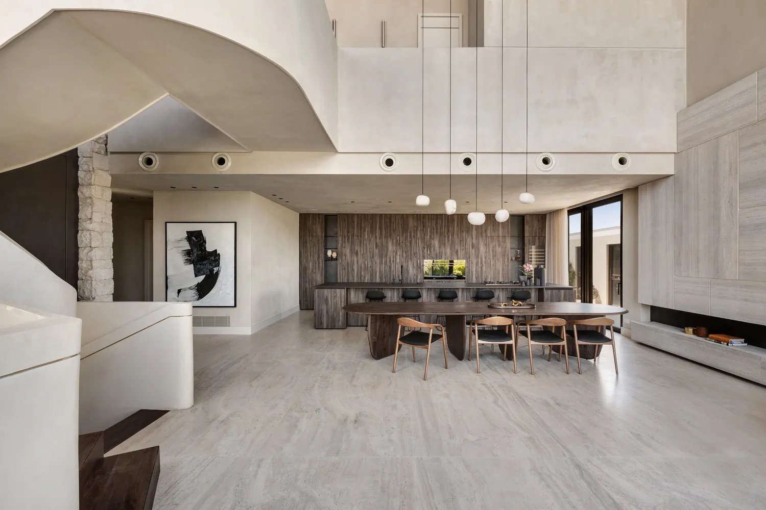 Contemporary residential kitchen featuring marble countertops, wooden cabinetry, and a modern design aesthetic.