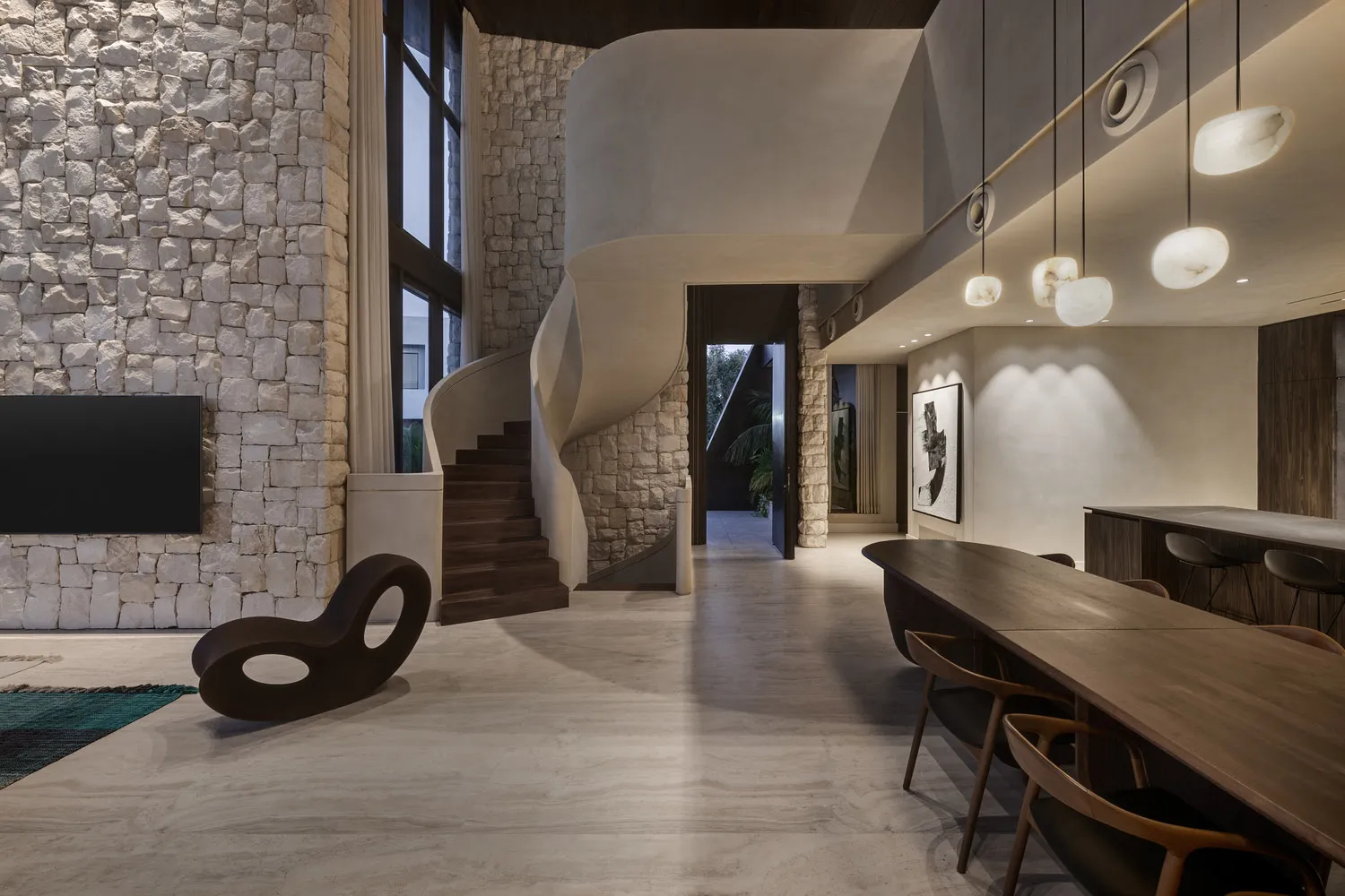Modern living room interior with concrete flooring, minimalist decor, and large windows.