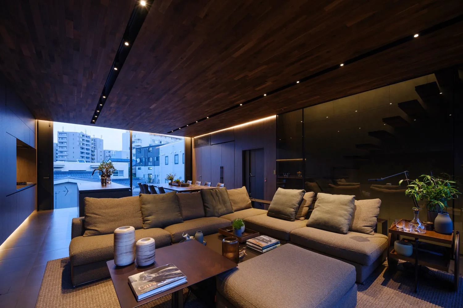 A modern living room with a gray sectional sofa and a coffee table with decorative items.