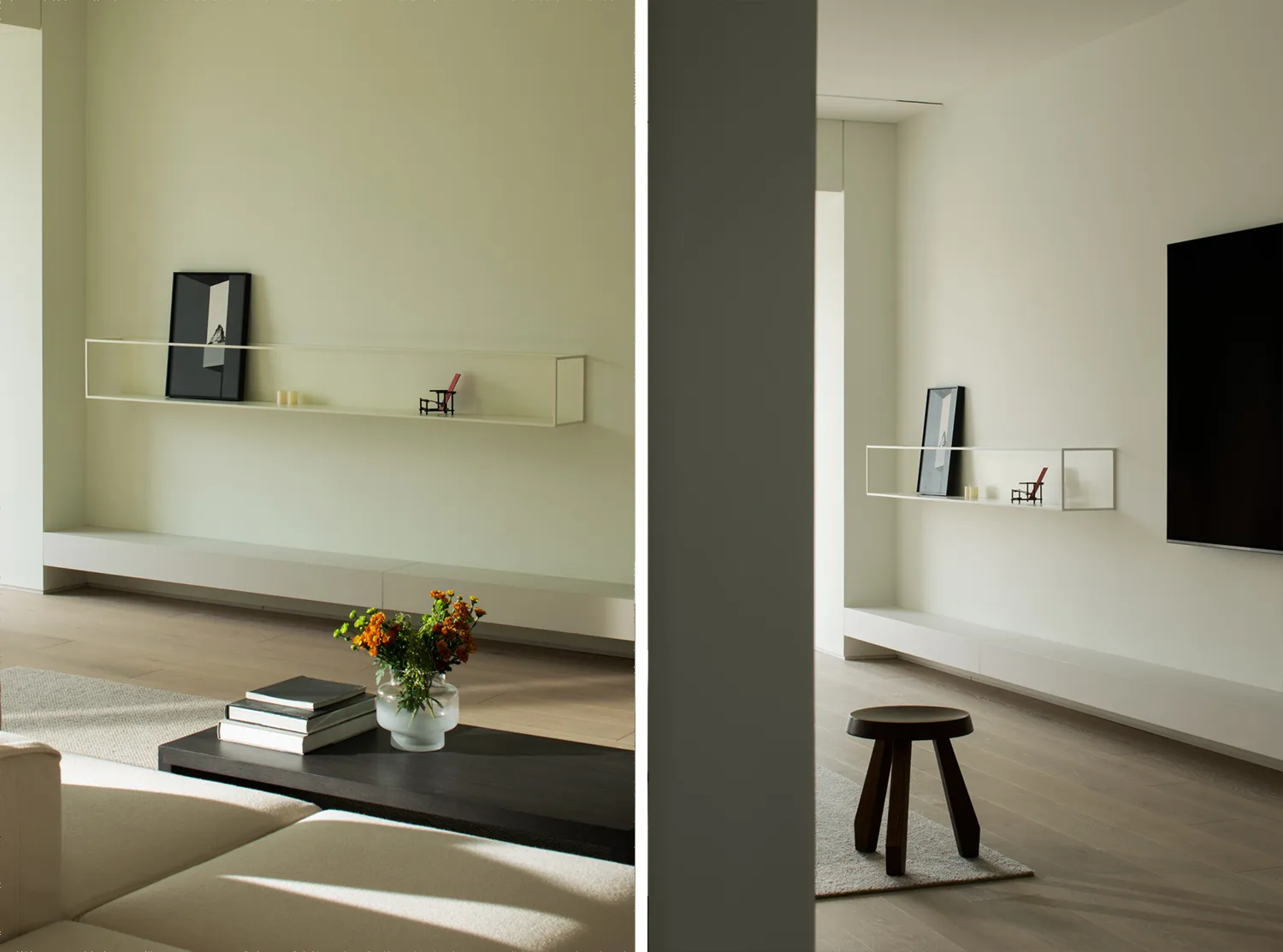 A minimalist living room featuring a sleek, low-profile white entertainment center with a TV and floating shelves, a dark woo
