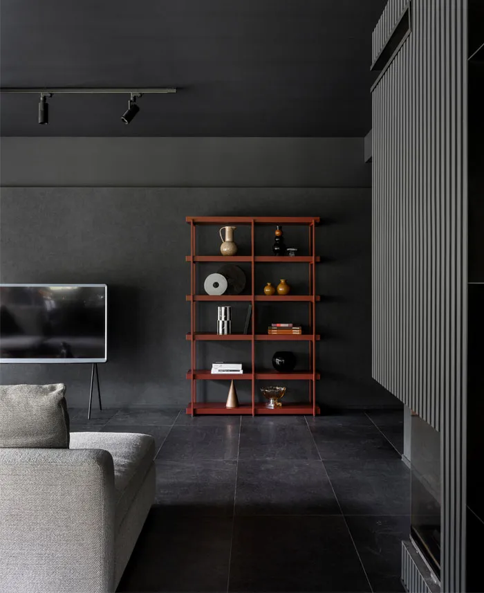 Modern living room featuring metallic shelving with decorative items and a minimalist design.