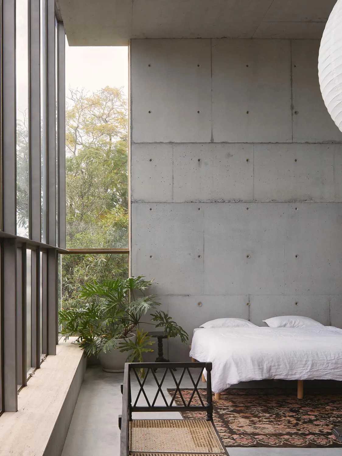 Minimalist bedroom with concrete and glass materials