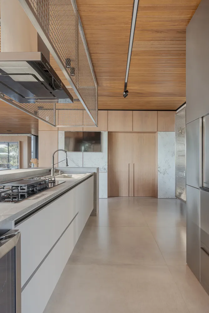 Modern residential kitchen with concrete, marble, and wooden elements.
