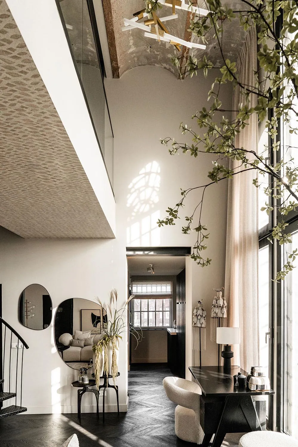 Modern living room with mixed-media decor and a high ceiling.