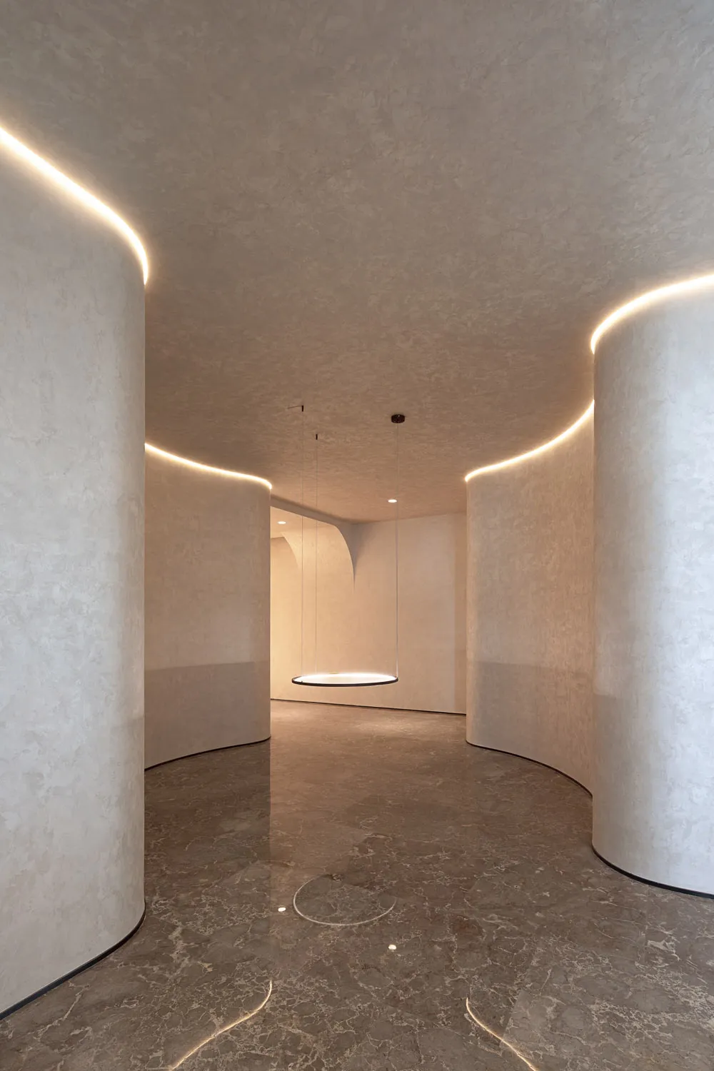 A minimalist interior space with concrete walls and floor.