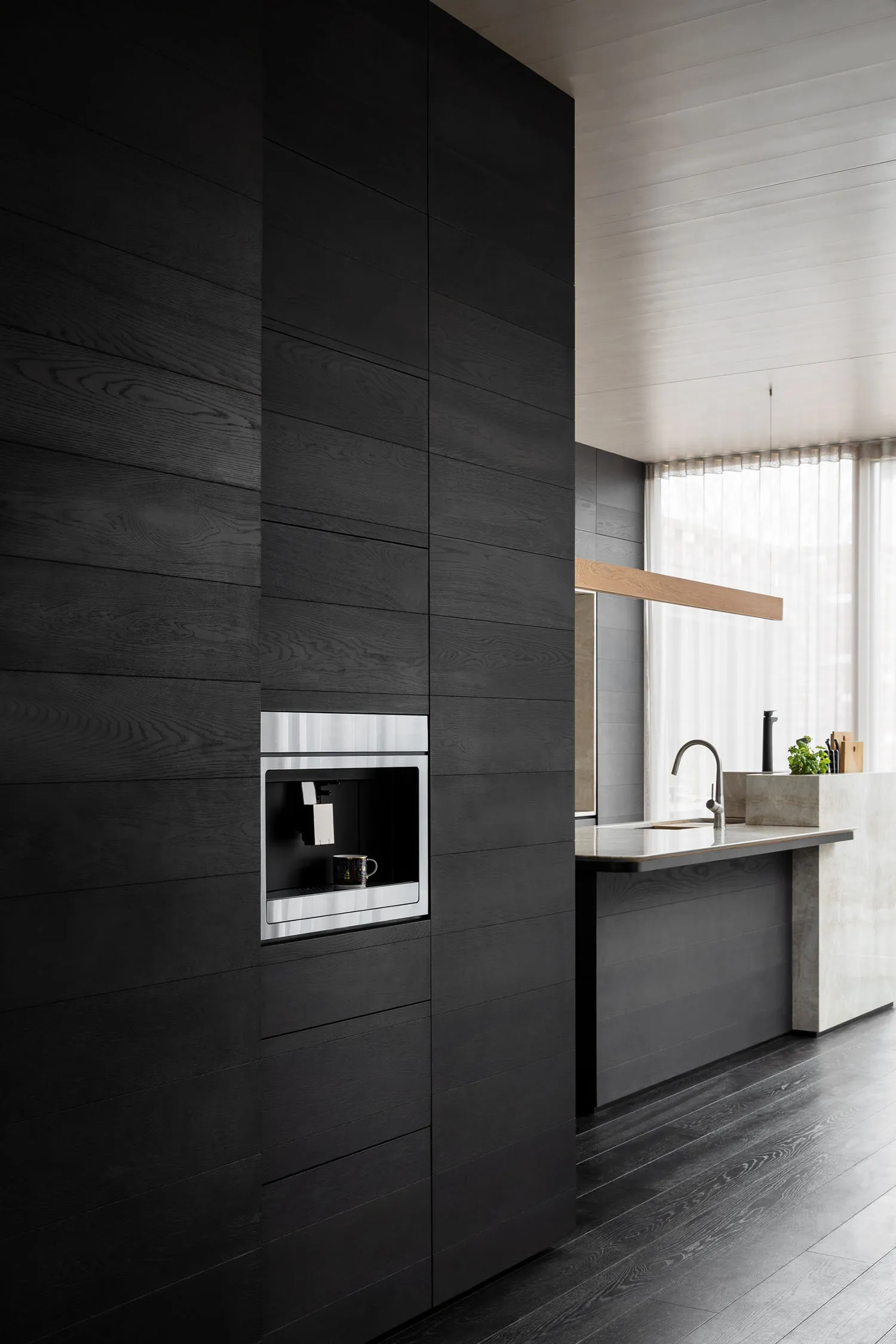 Modern kitchen with dark wood cabinets and minimalist design