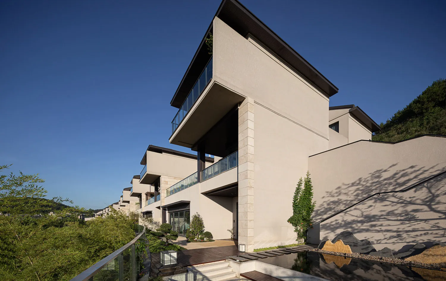 Modern residential homes featuring sleek, minimalist architecture with concrete and glass materials.