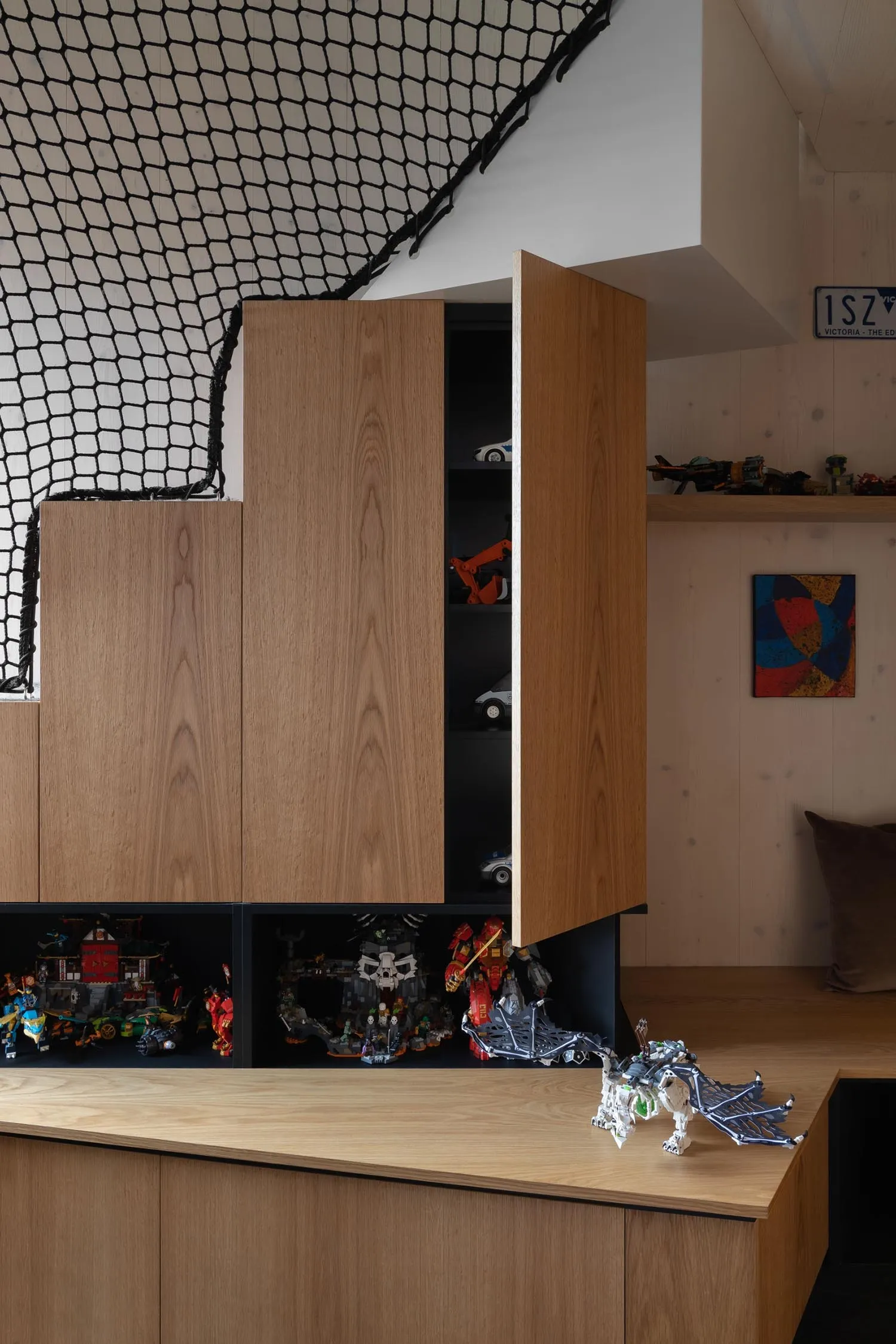 Modern interior design featuring a wooden storage unit with a container for toys in a living space
