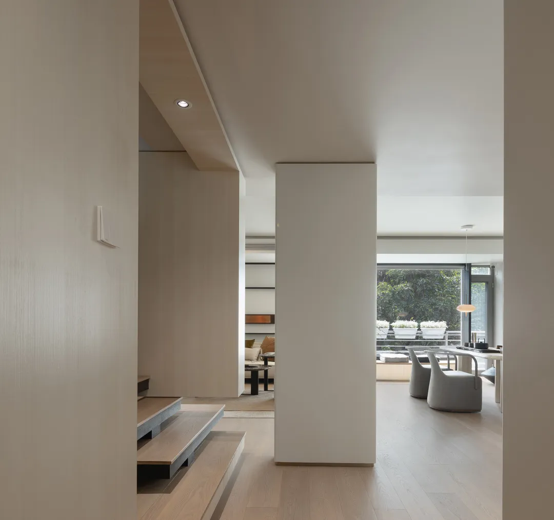 An image depicting a modern minimalist residential interior with a focus on wood elements.