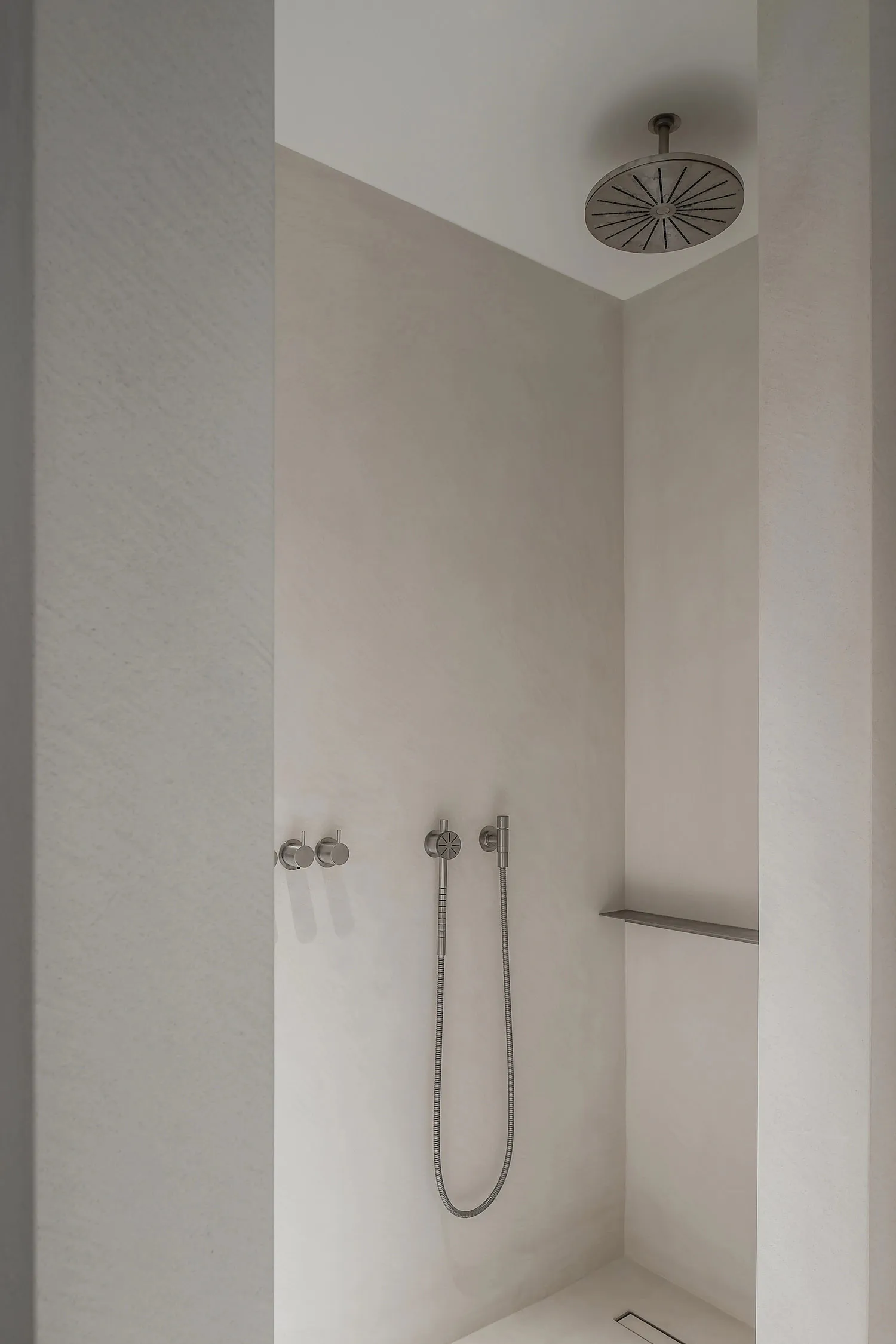 A modern concrete bathroom with minimalist design elements and clean lines.