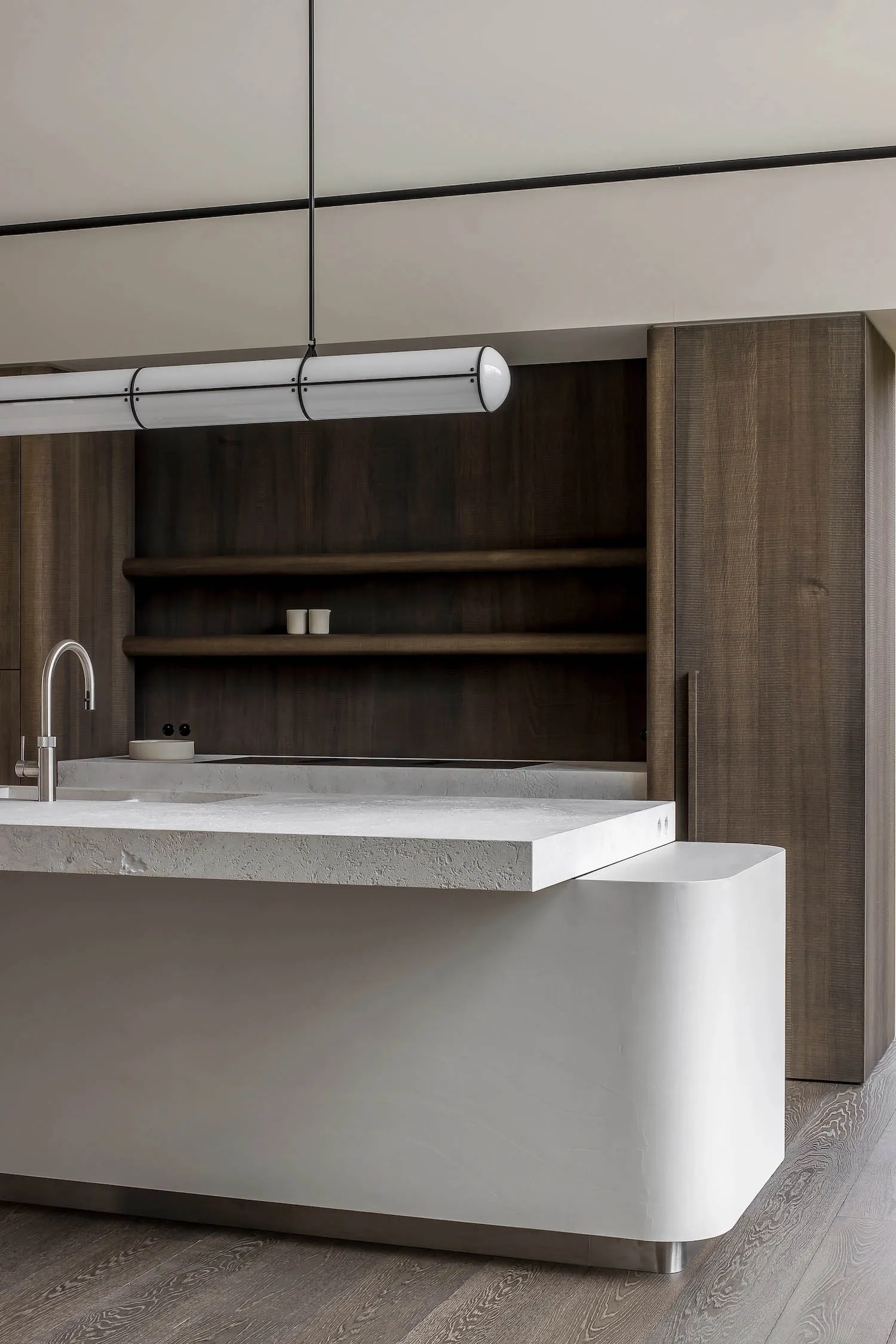 Modern kitchen with clean lines, concrete countertops, and wooden shelves.