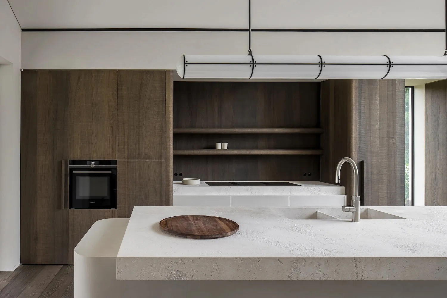 Modern interior kitchen featuring a concrete countertop and minimalist design.
