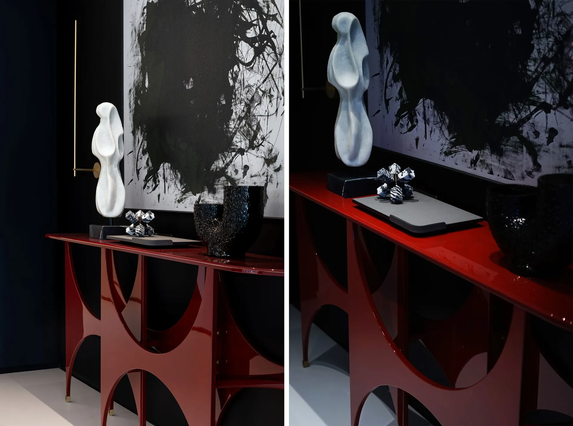 Modern console table featuring black and white contrast, with sculptures and vases adorned on its surface.