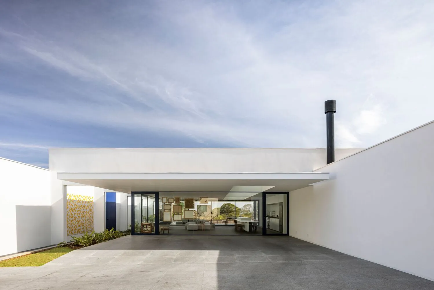A modern residential space featuring concrete and glass materials.