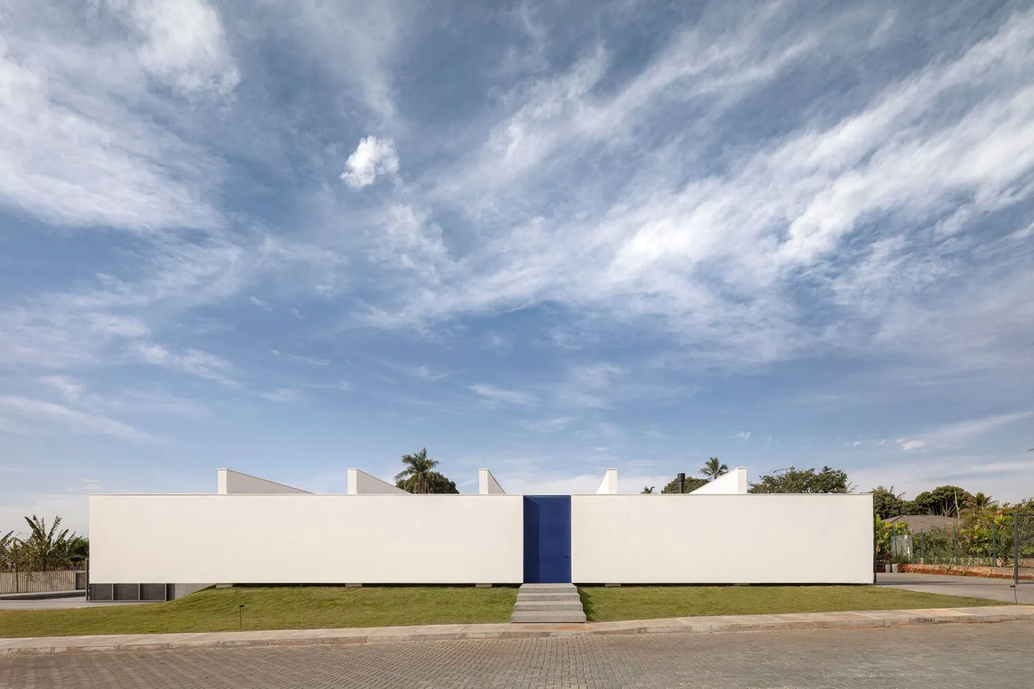 A sleek, modern building facade rendered in pure white, evoking a sense of minimalism and contemporary architecture.