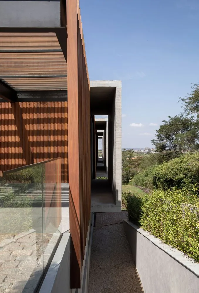 Modern architectural design featuring glass walls and concrete elements.