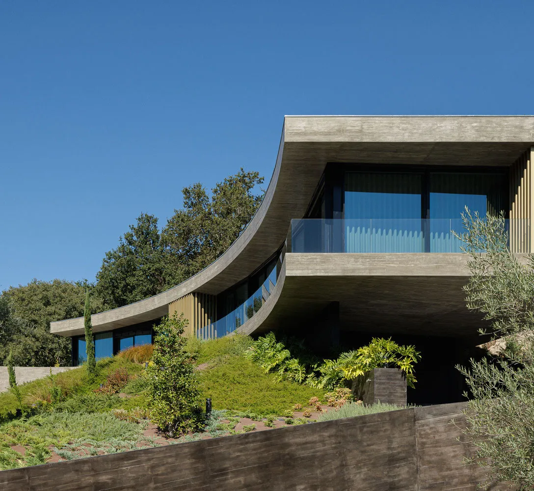 A modern building exterior with concrete and glass materials.