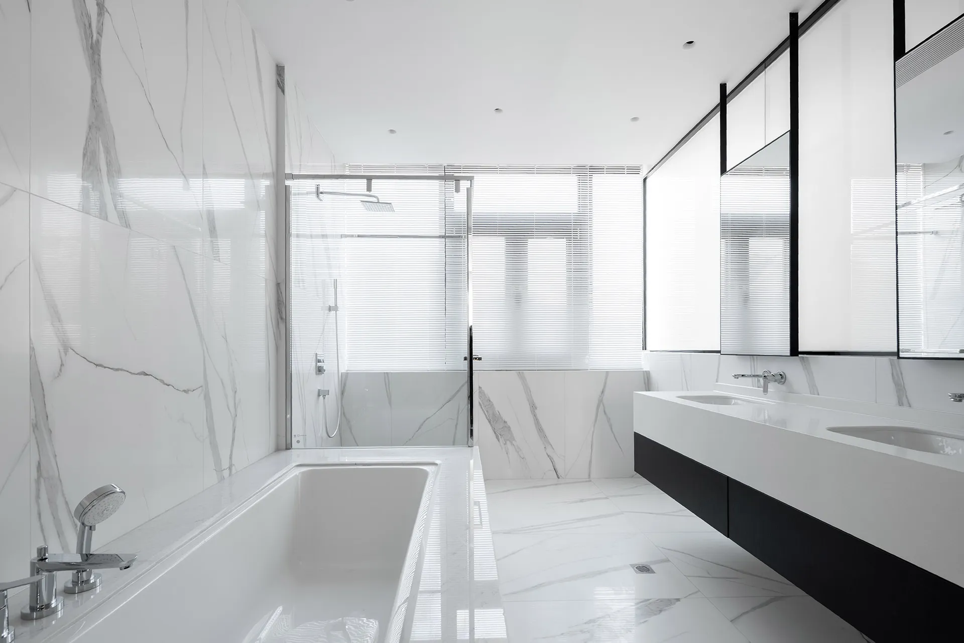 Modern minimalist bathroom featuring white marble elements and a sleek design.
