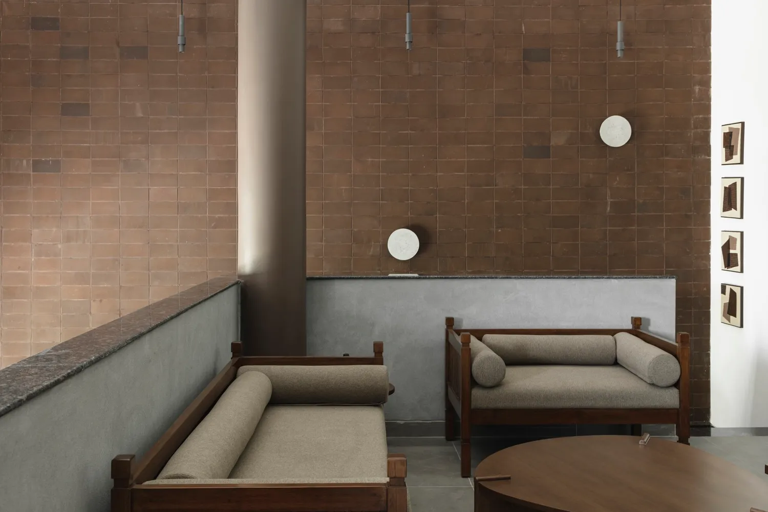 Minimalist interior design featuring wooden furniture and fabric seating.