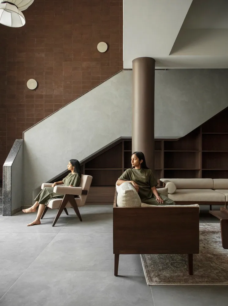 People sitting in a modern living room with neutral tones and minimalist furniture