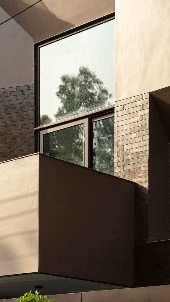 A modern architectural design with a large glass window.