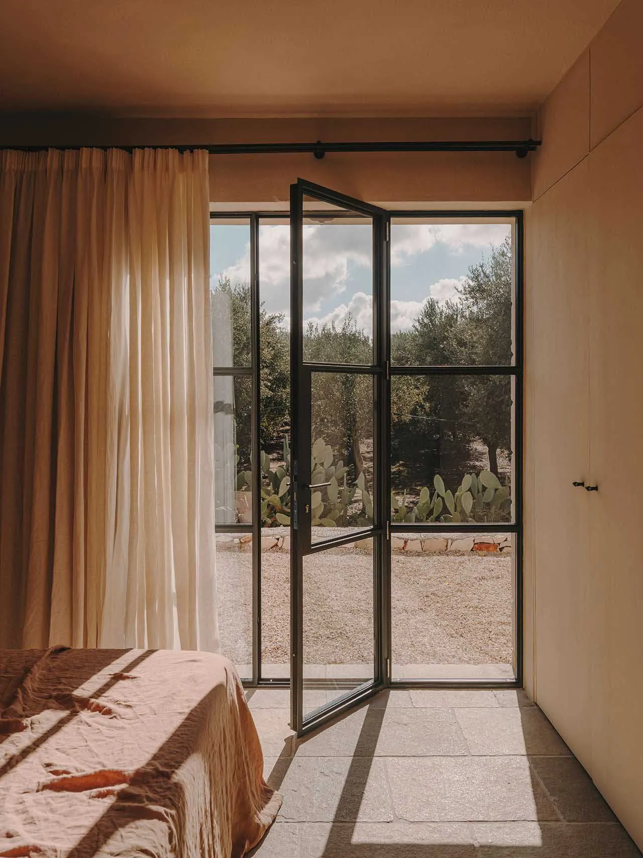 Modern bedroom with glass door and concrete floor