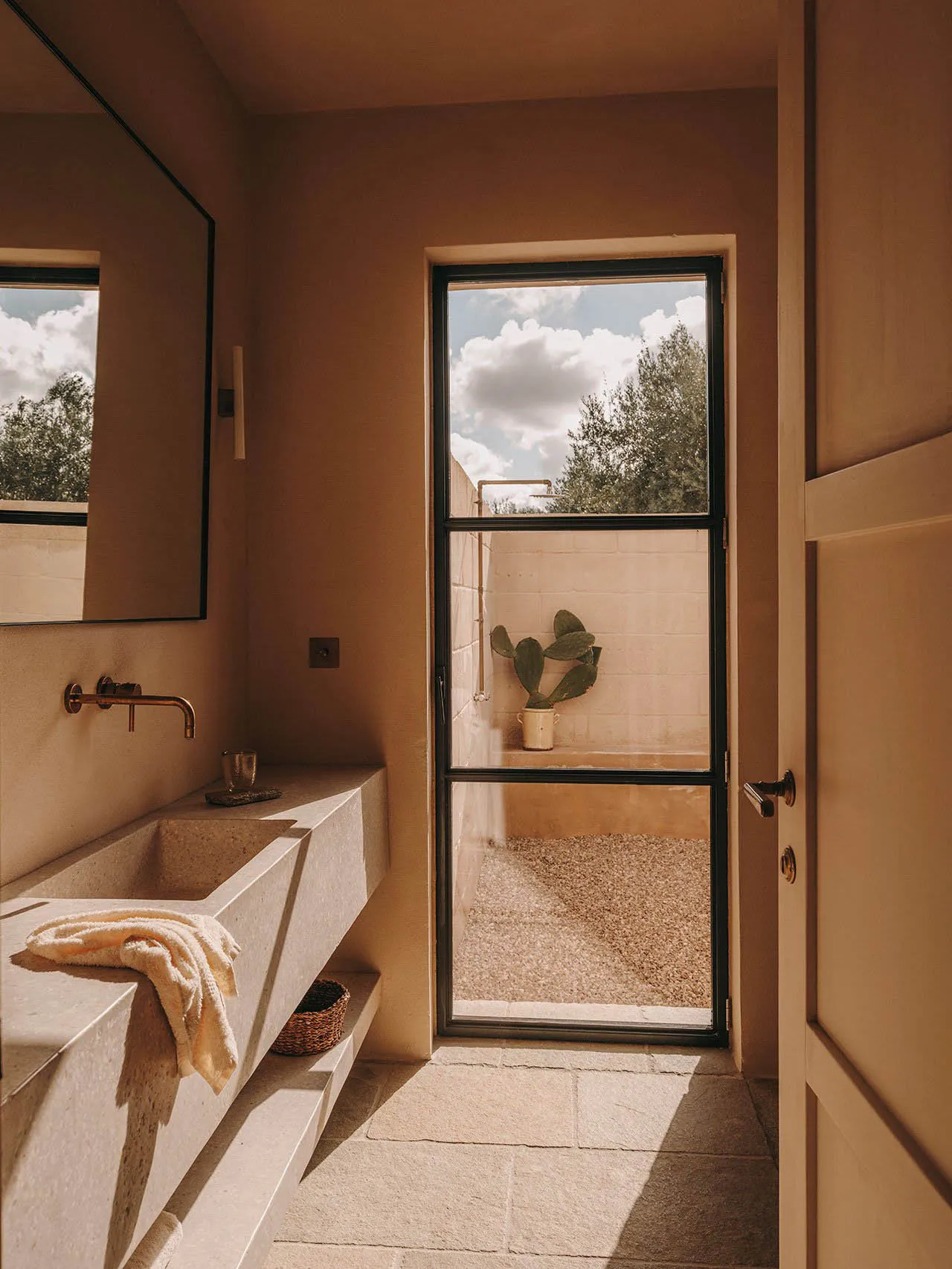 Interior design featuring a contemporary bathroom with concrete elements and natural light.