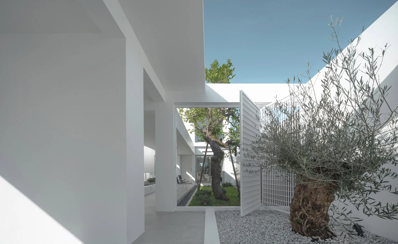Modern house exterior with glass walls and white exterior