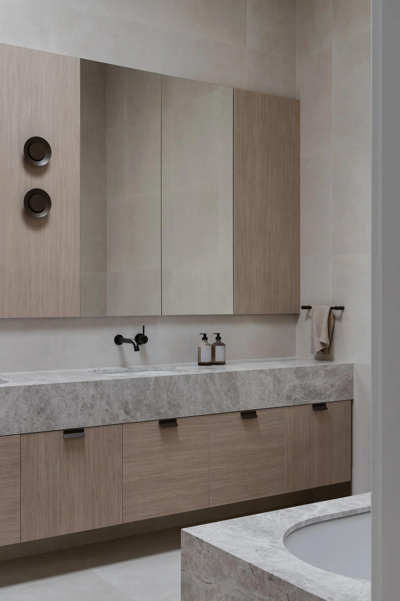 Modern minimalist bathroom featuring marble finishes and sleek design elements.