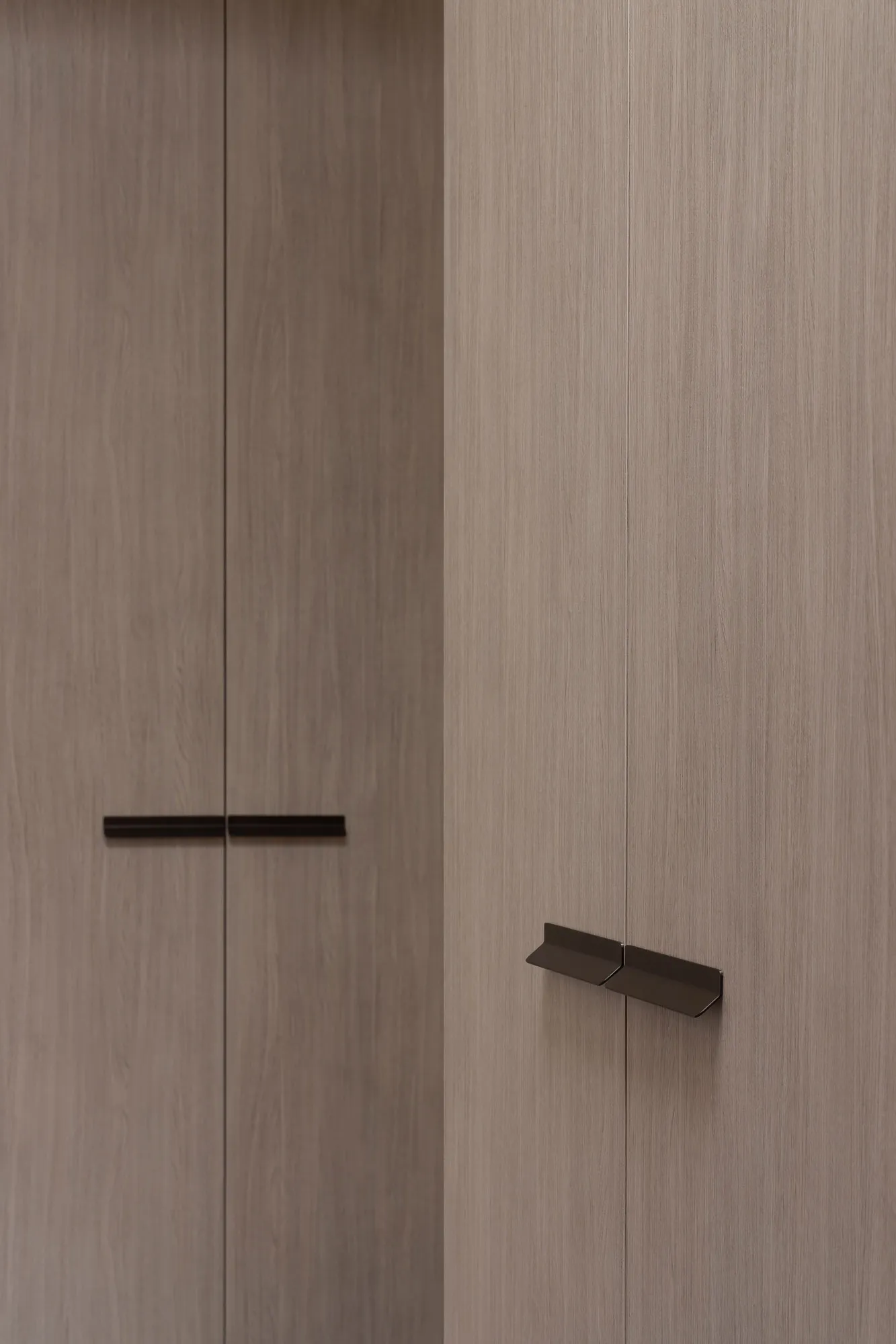 Minimalist design of wooden cabinets in an interior setting.