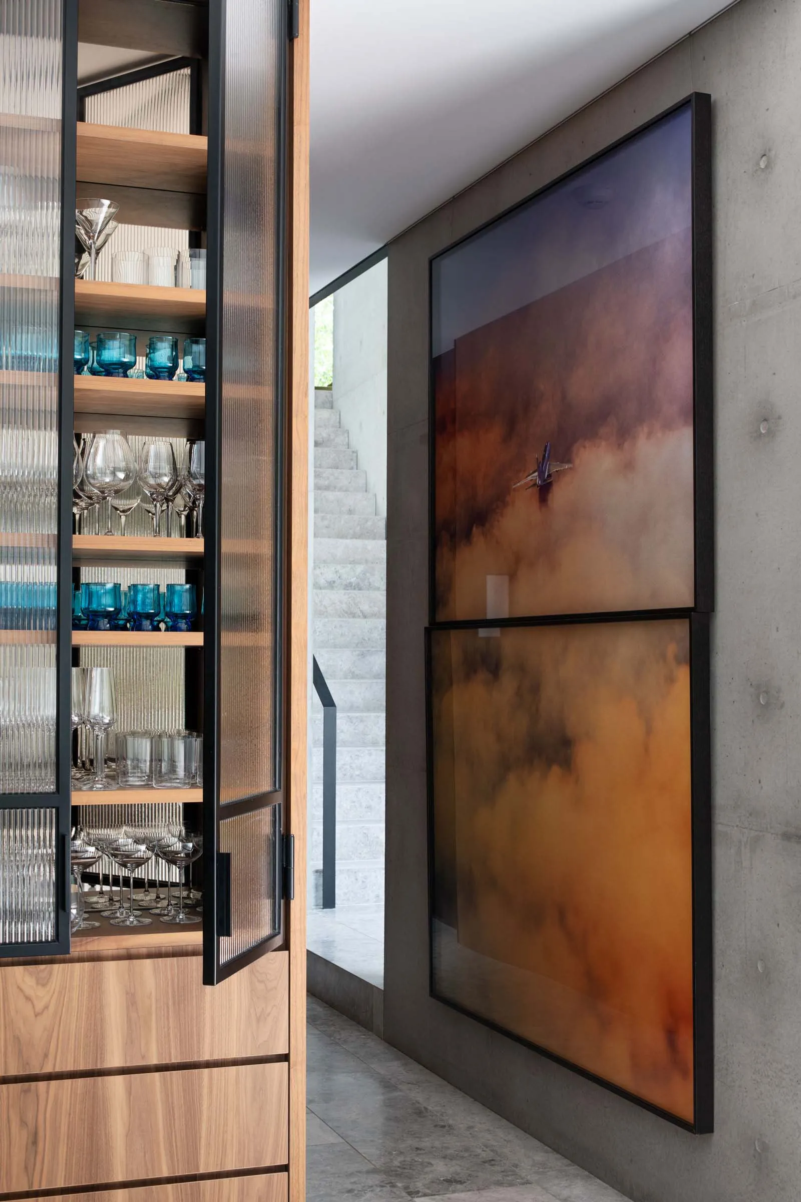 Modern entryway featuring wood, cement, and glass materials