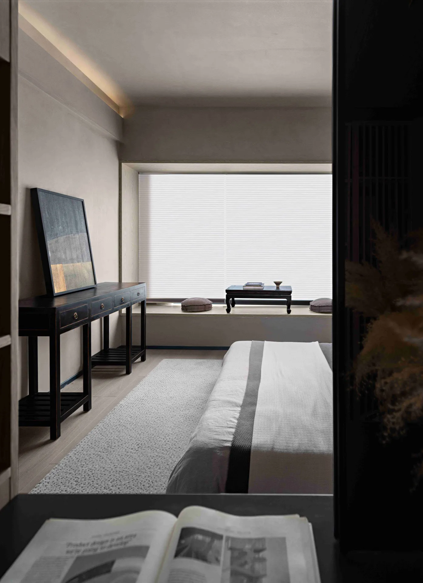 Modern minimalist bedroom with textured materials and a serene ambiance.