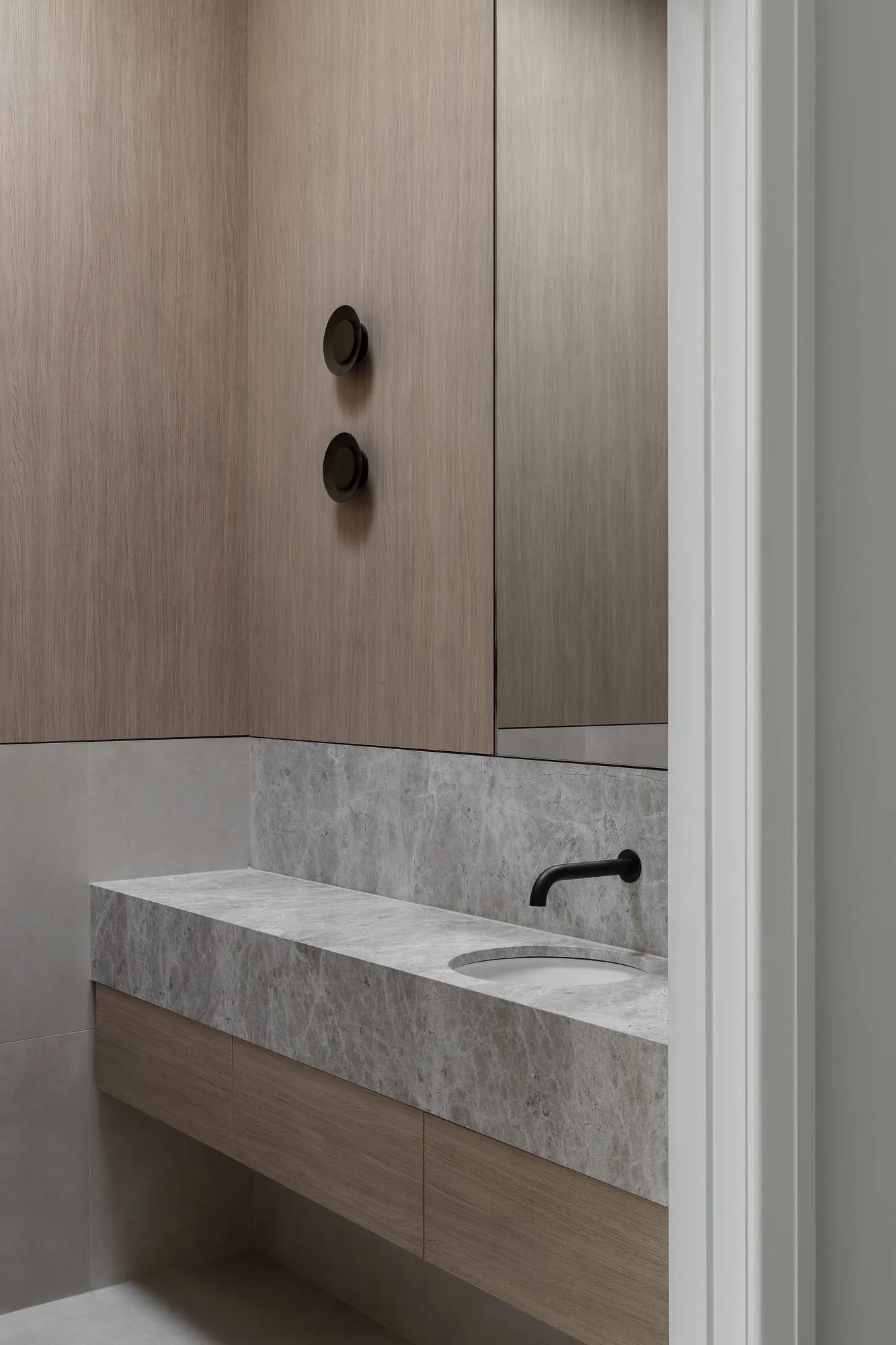 Modern bathroom with marble countertop and floating cabinet.