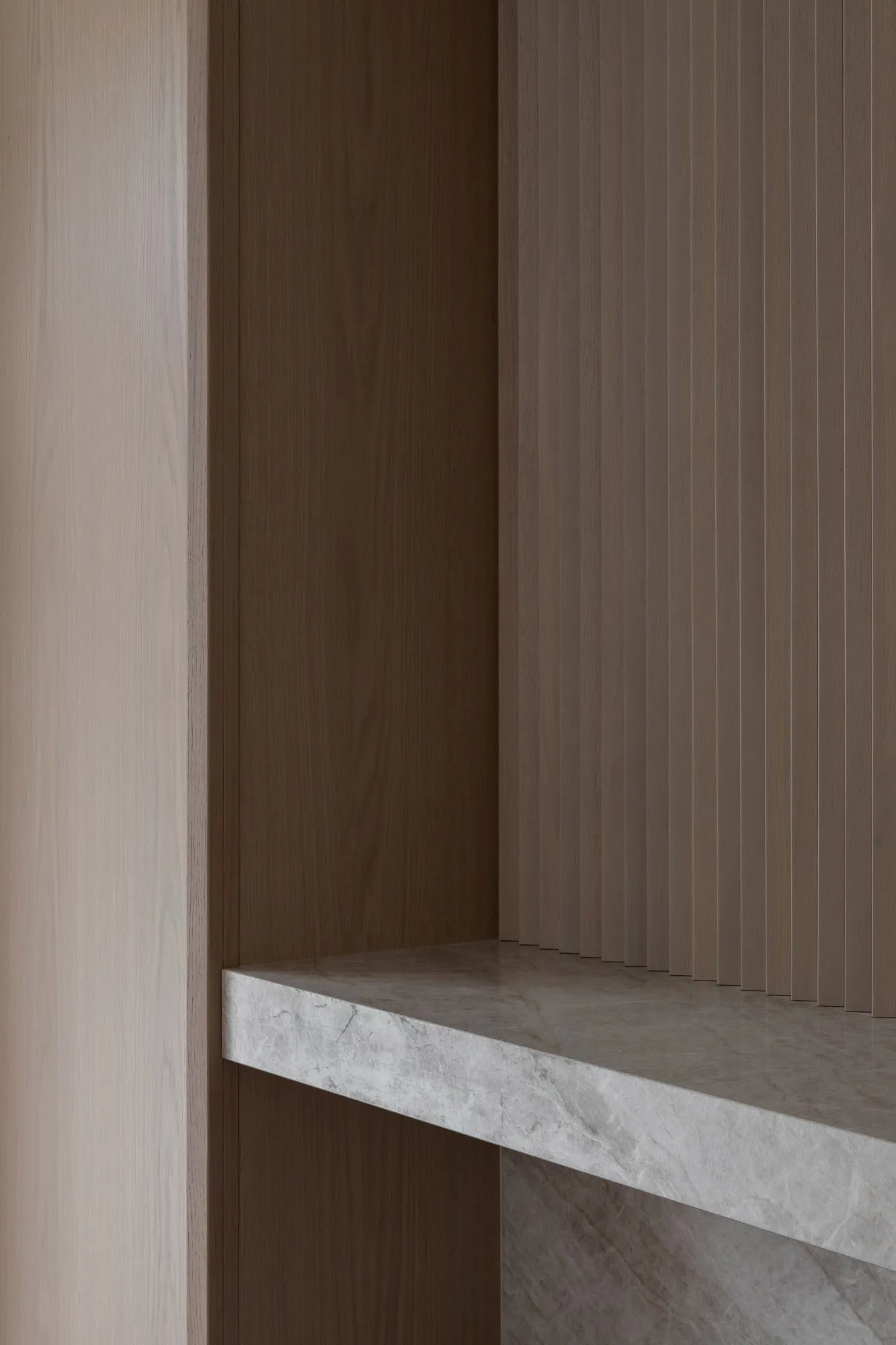 A minimalist interior design featuring marble and concrete materials.