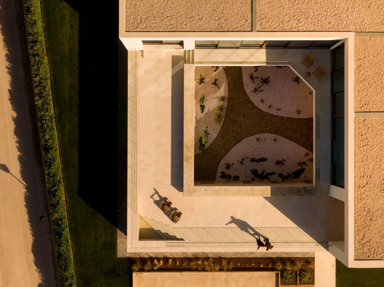 An aerial view of a contemporary landscape featuring geometric shapes and concrete material.