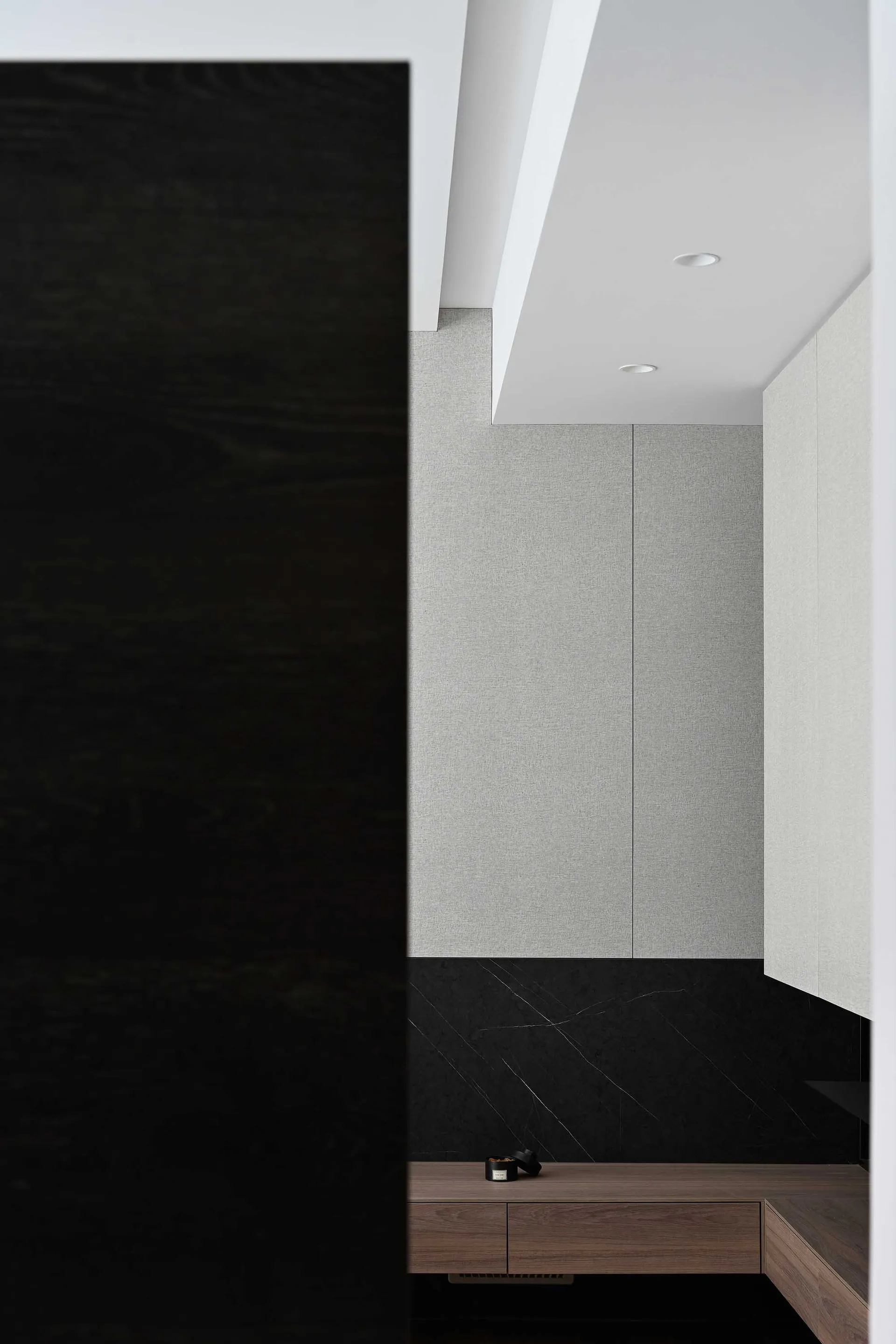 Modern closet interior featuring gray tiles and black ground.