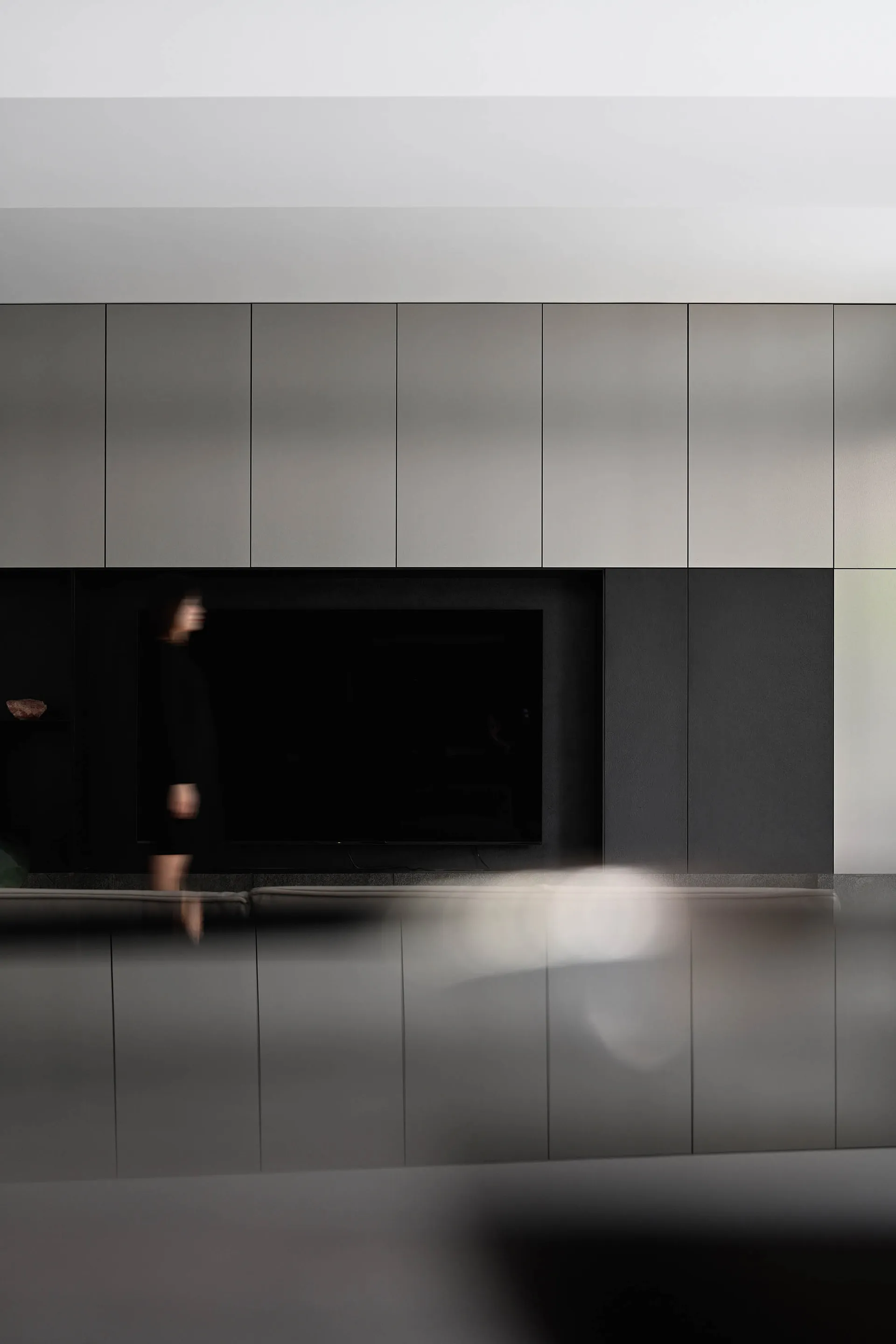 A modern living room featuring a black and white color palette with metallic accents.