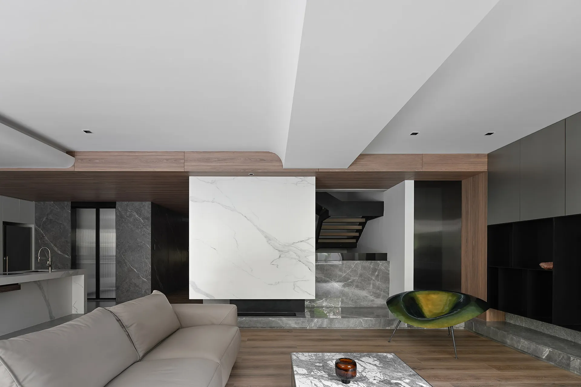 A modern living room featuring marble accents and wooden elements.