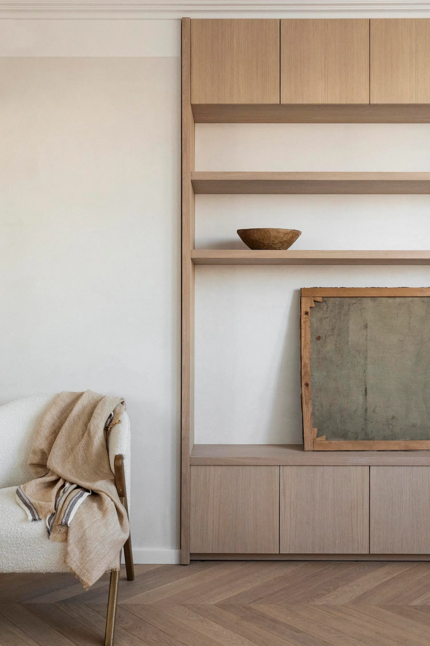 A modern minimalist living room featuring wooden shelving.