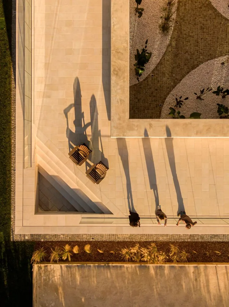A modern patio featuring concrete flooring and seating areas.