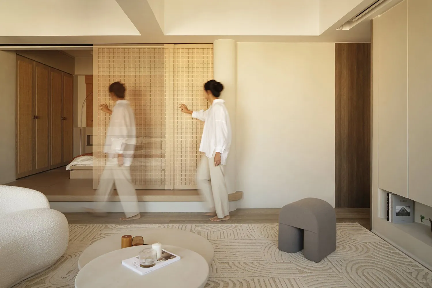 A modern living space featuring neutral-toned decor and furniture.