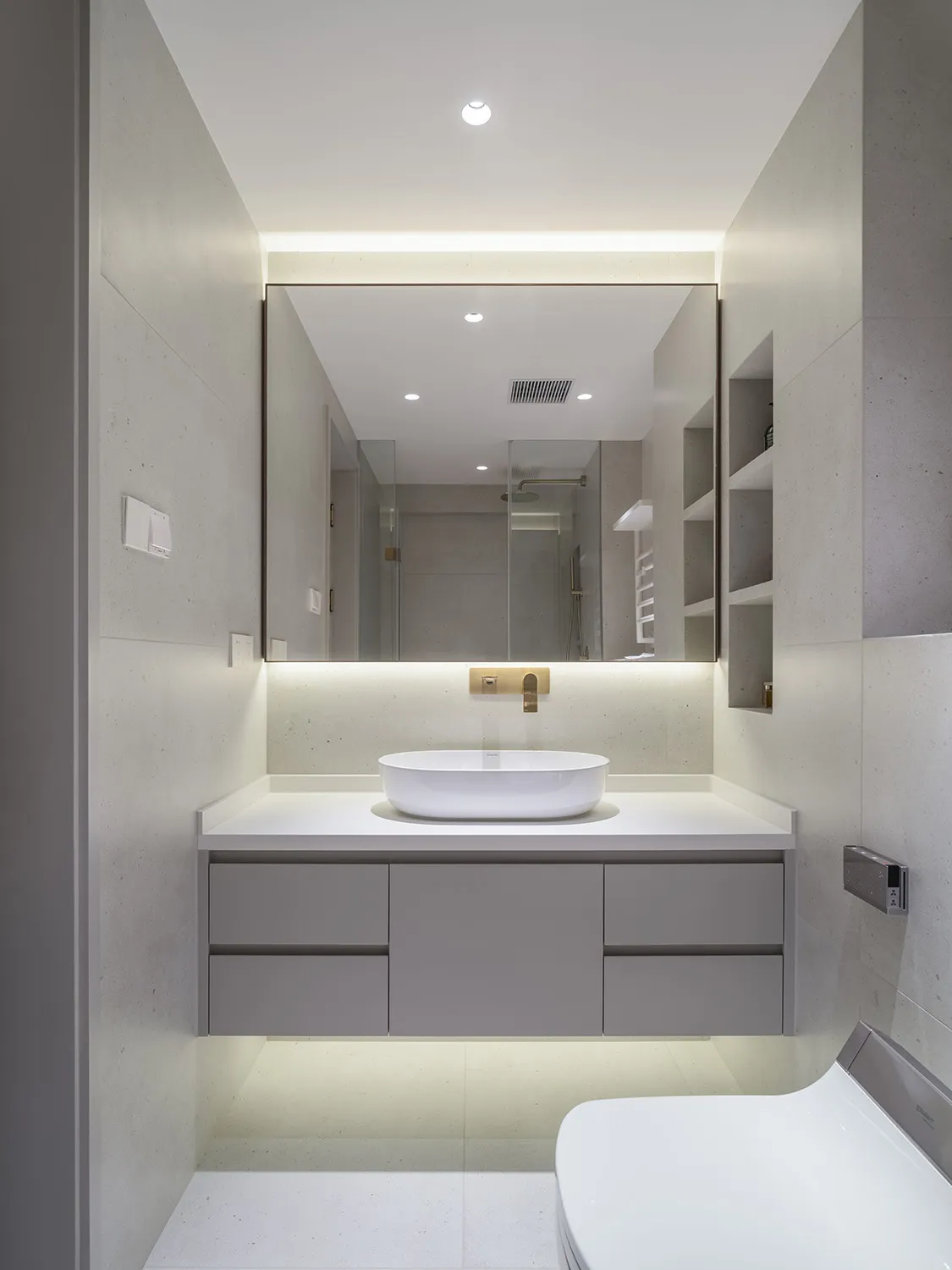 A modern bathroom featuring a sleek, minimalist design with concrete and glass elements.