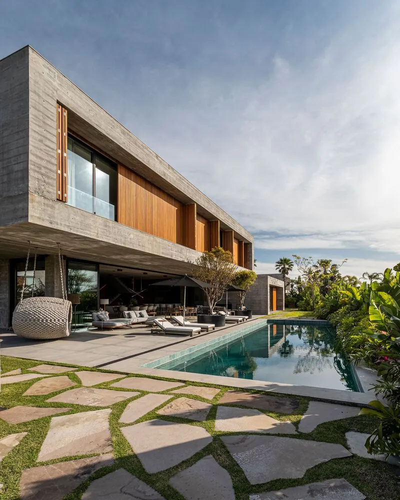 Modern house with a contemporary design featuring concrete and glass materials.