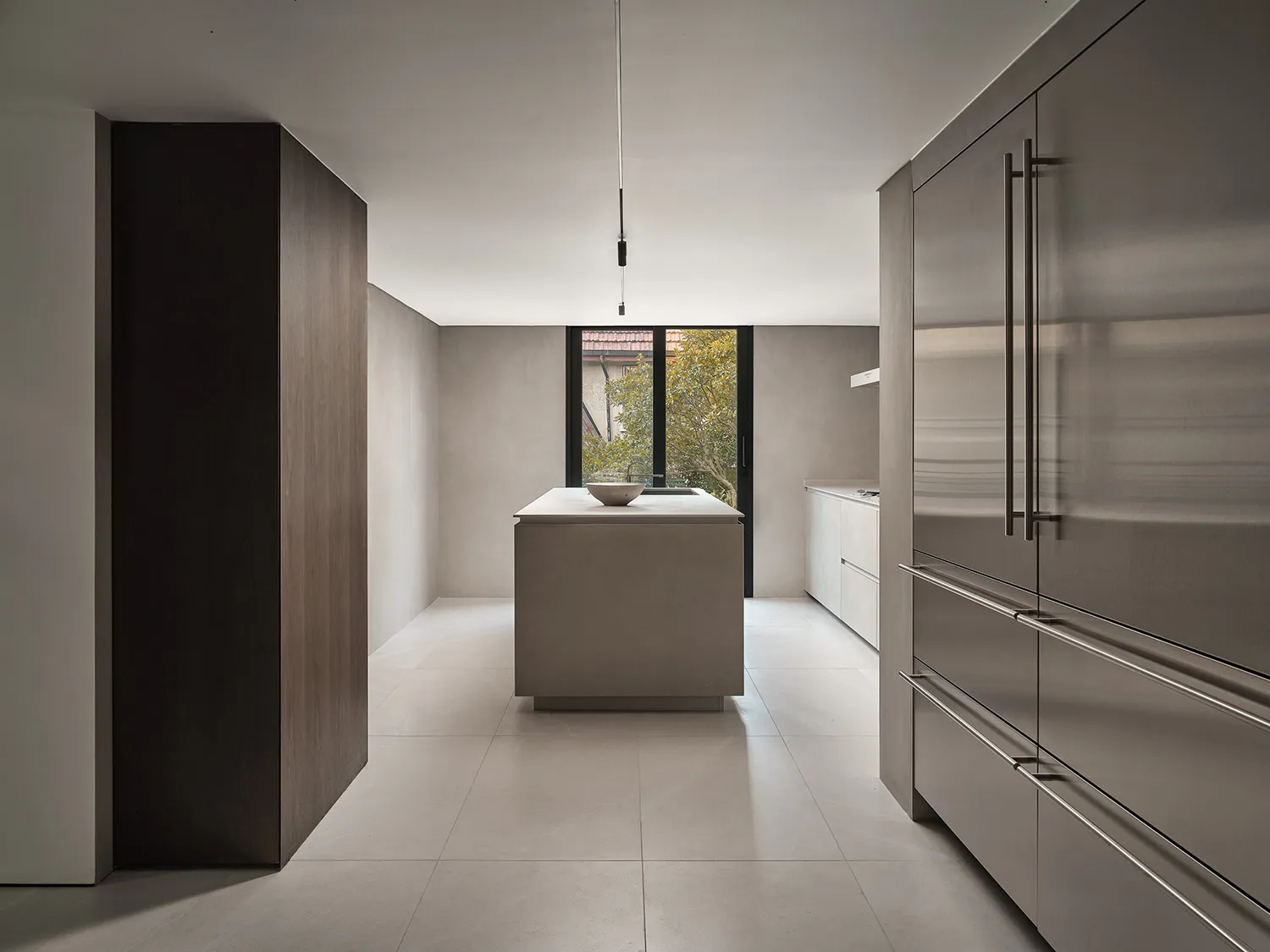 Contemporary kitchen with concrete countertop and minimalist island.